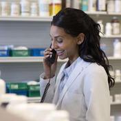 A registered pharmacist counsels a patient 